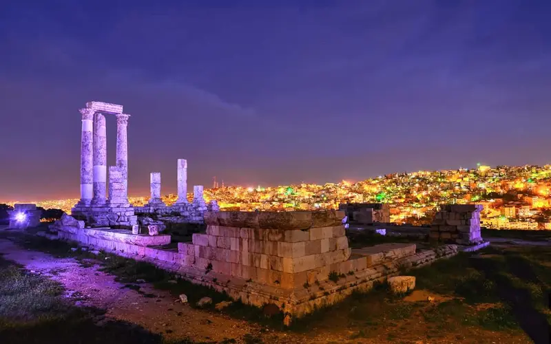 The Amman Citadel lit at night above the city