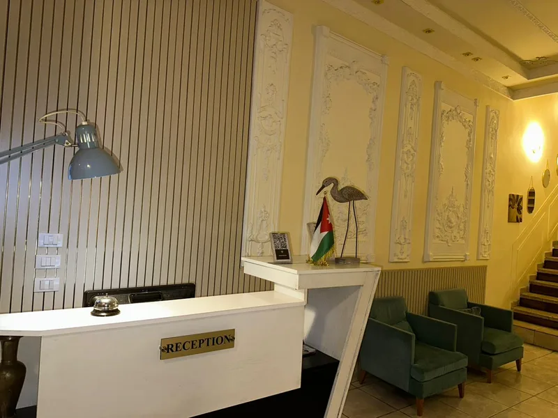The reception desk and the lobby chairs, under the moulded plaster