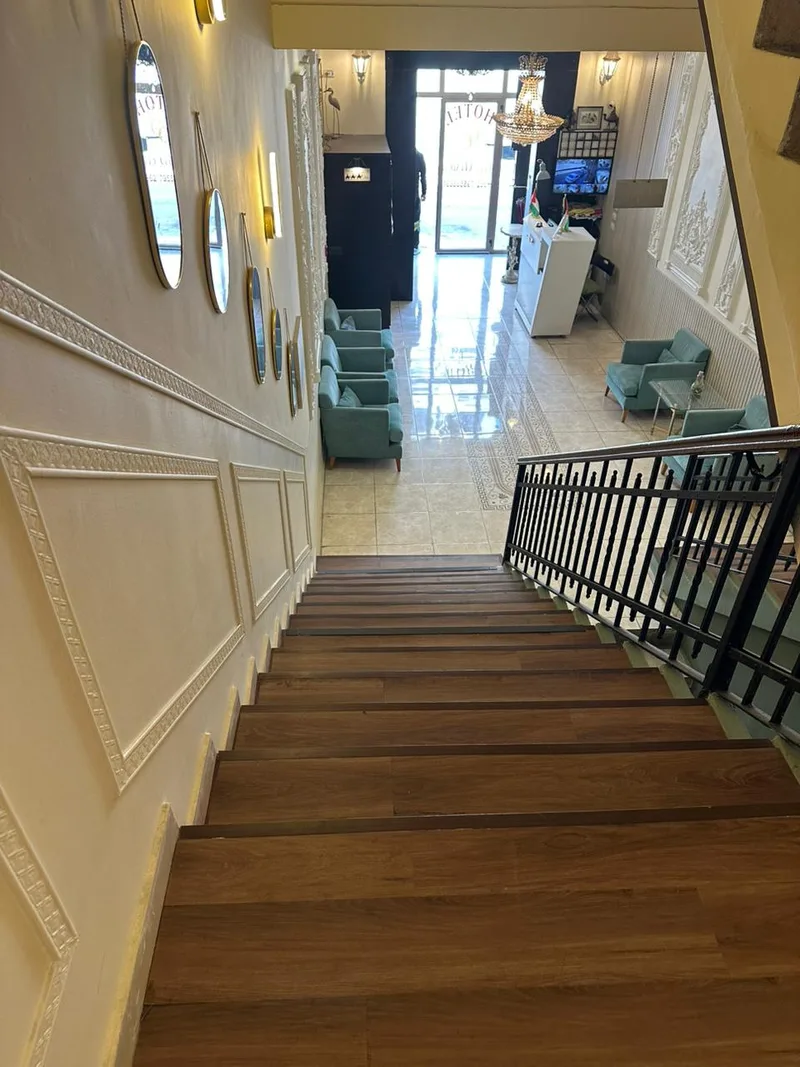The stair down to the lobby, past the mirrors